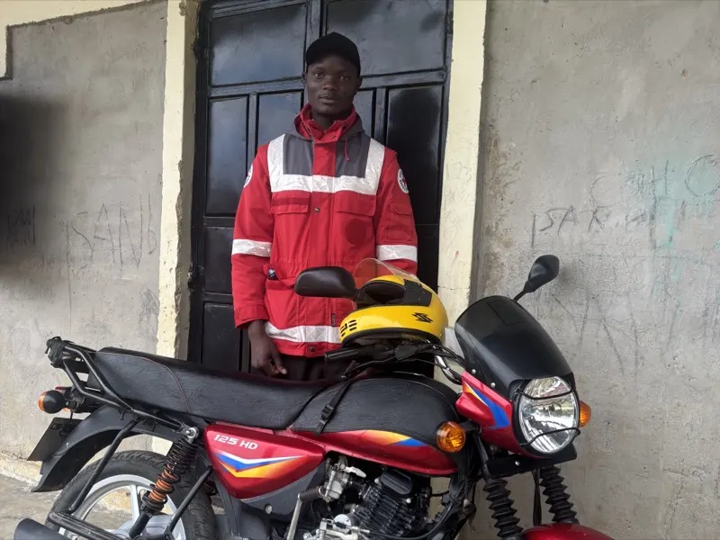 A member of Waweza's medical team with the clinic's motorbike