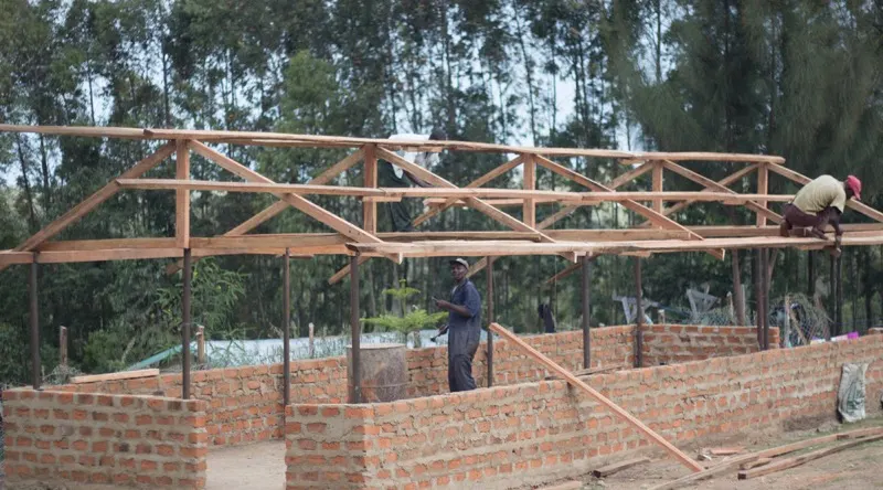 Builders putting the roof on the Waweza Rescue Center