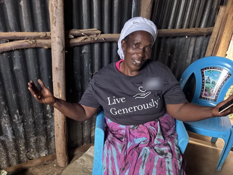A widow in our program with sacks of grain from her business